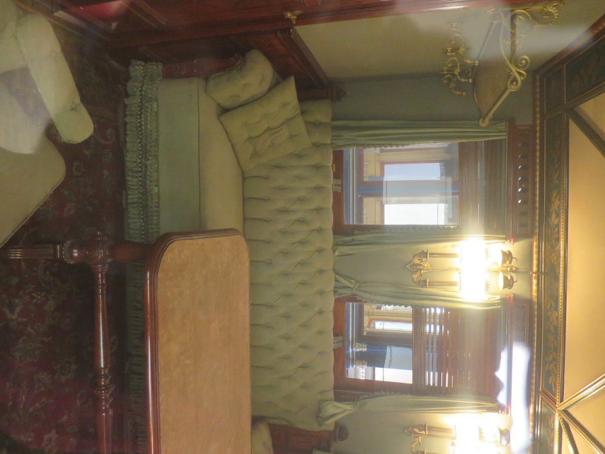 Interior of Otto von Bismarck's saloon car with luxurious red upholstery and detailed wood paneling