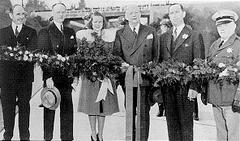Ribbon cutting ceremony at Arroyo Seco Parkway opening in 1941 with officials and Rose Festival Queen