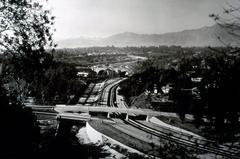 1940 aerial view of Arroyo Seco Parkway with Avenue 64 and York Street bridges overlooking San Gabriel mountains in California