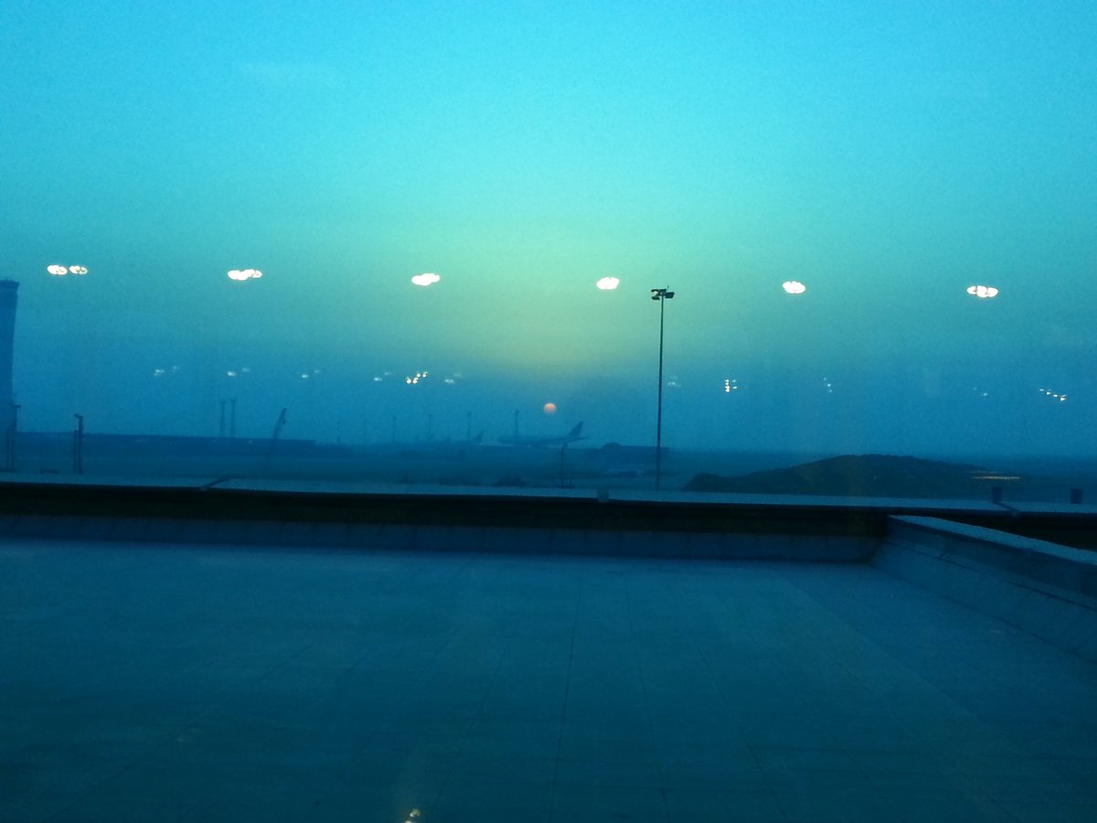 A wide view of Cairo International Airport terminal building with airplanes on the tarmac