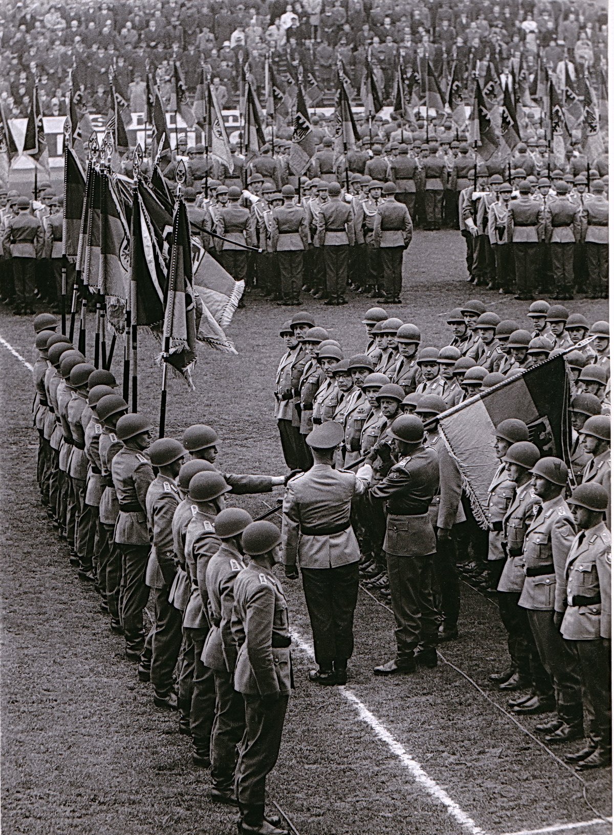 General Ulrich de Maiziere handing over troop flags to selected battalions at Preussenstadion, Münster, April 24, 1965