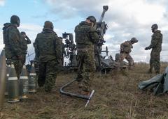 U.S. Army Sgt. Carlos Vela firing Canadian M777 howitzer with NATO allies during Exercise Wawel Dragon at Bemowo Piskie Poland