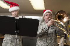 Tech. Sgt. Mike Pekarek and Tech. Sgt. John Caputo of the U.S. Air Force Band of the West Gateway Brass playing holiday music at Wilford Hall Ambulatory Surgical Center