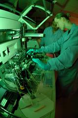 Staff Sgt. Kristin Parsons loading reagents into allergy testing machine in diagnostic immunology lab