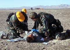 Pararescueman from California Air National Guard and Chilean Air Force members treating simulated crash survivor in Atacama Desert