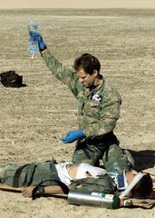 Senior Master Sgt. Tim Young treating simulated crash survivor in Atacama Desert medical exercise