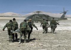 Pararescuemen from California Air National Guard and Chilean Air Force carrying simulated crash victims to helicopter in Atacama Desert