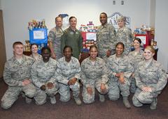 U.S. Air Force and Army officers standing behind donated food items for a local food bank at Lackland Air Force Base