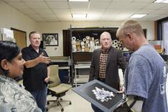 Retired Master Sgt. William Vance presenting PTSD artwork to Lt. Col. Kenneth Dwyer at Wilford Hall Ambulatory Surgical Center