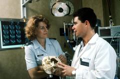 Major Dr. John H. Schneider, an Air Force neurosurgeon, demonstrating skull reconstruction to Captain Margaret Herring at Wilford Hall Medical Center