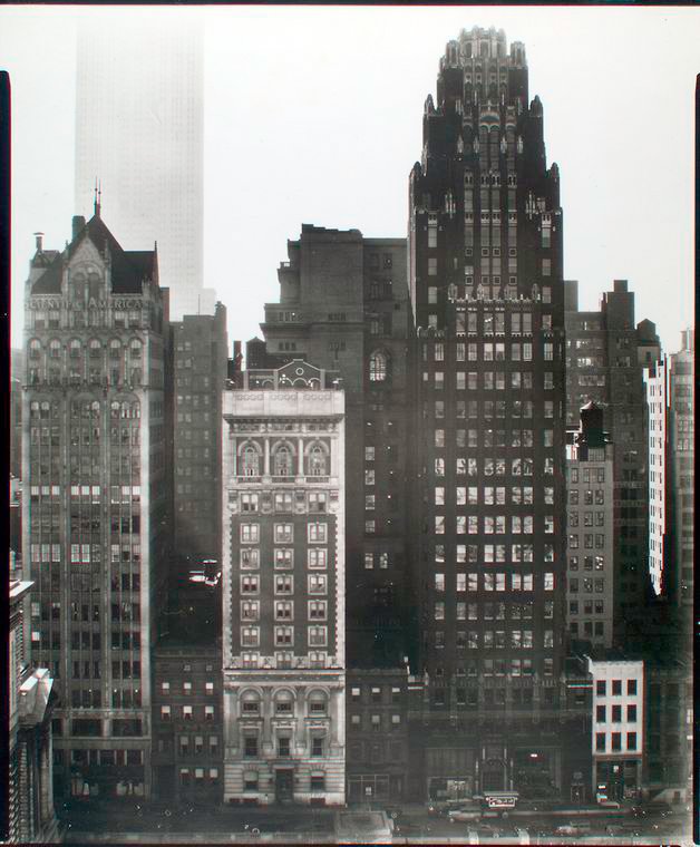 View of 40th Street between Fifth and Sixth Avenues in Manhattan across Bryant Park with Scientific American and American Radiator Buildings and Empire State Building in distance in 1935