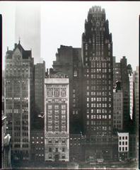 View of 40th Street between Fifth and Sixth Avenues in Manhattan across Bryant Park with Scientific American and American Radiator Buildings and Empire State Building in distance in 1935