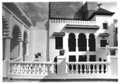 Exterior view of the American Legation building in Tangier, Morocco, showing traditional architecture with bright white walls and decorative green doors and windows
