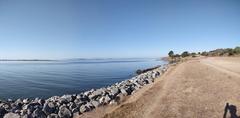 View of Albany Bulb park with a bike trail and urban skyline in the background