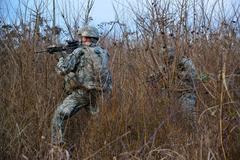 U.S. Army paratroopers patrolling through vegetation during training in Italy