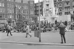 Youth and tourists gathered at the National Monument on Dam Square in Amsterdam on June 21, 1971