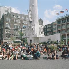 Crowded Dam Square with the National Monument in Amsterdam during summer 1982