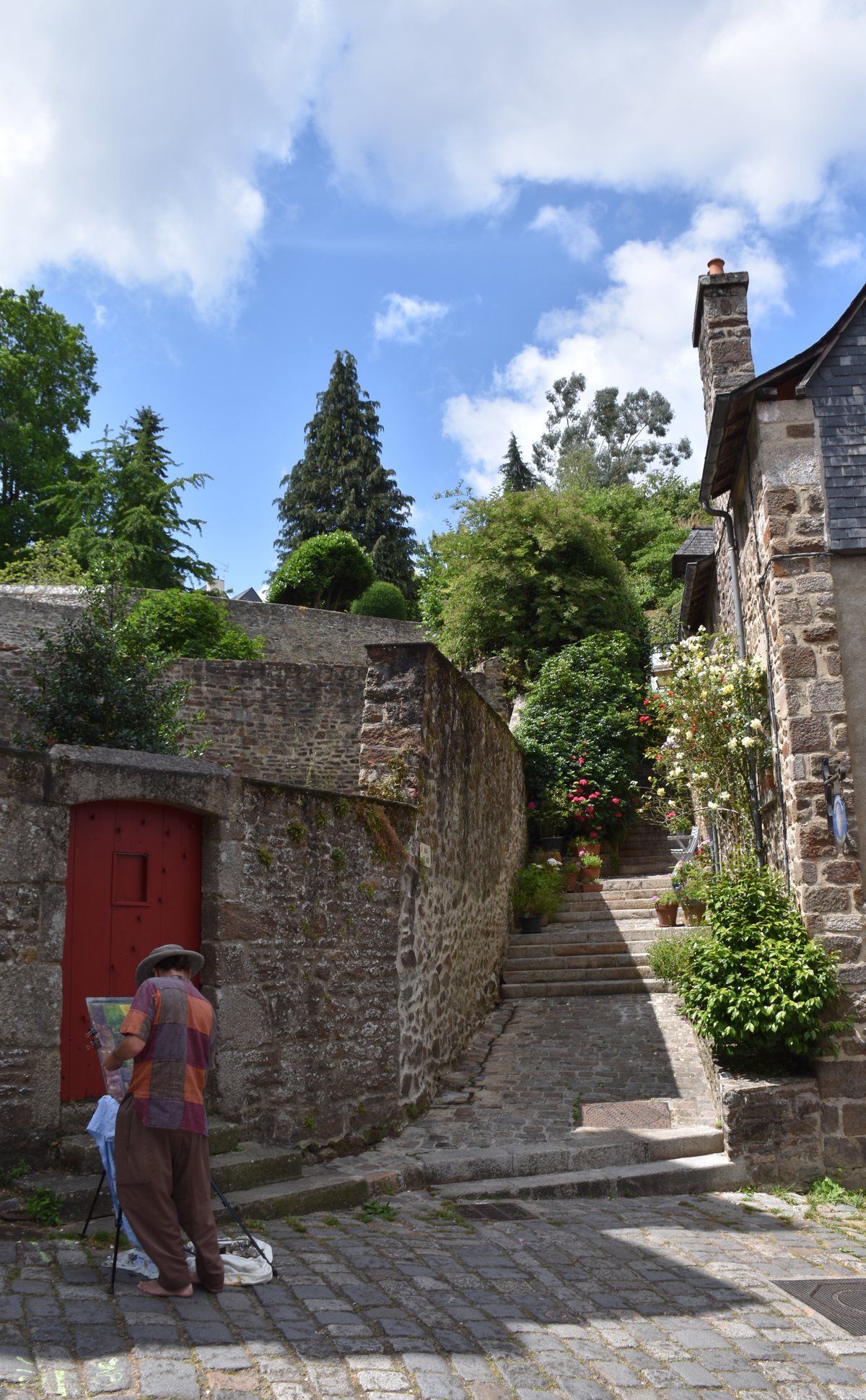Medieval cobblestone street La Rue Jerzual in Dinan, France with colorful half-timbered houses
