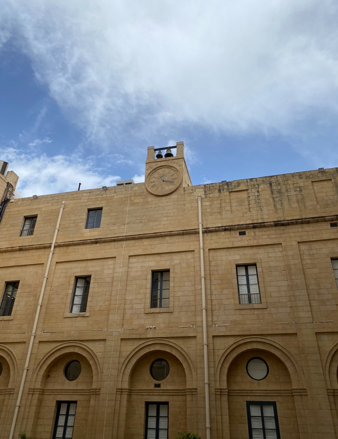 Courtyard at University of Malta Valletta Campus with historic buildings and arches