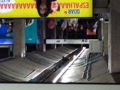 Exit of Ana Rosa Station with people walking and vehicles on the street
