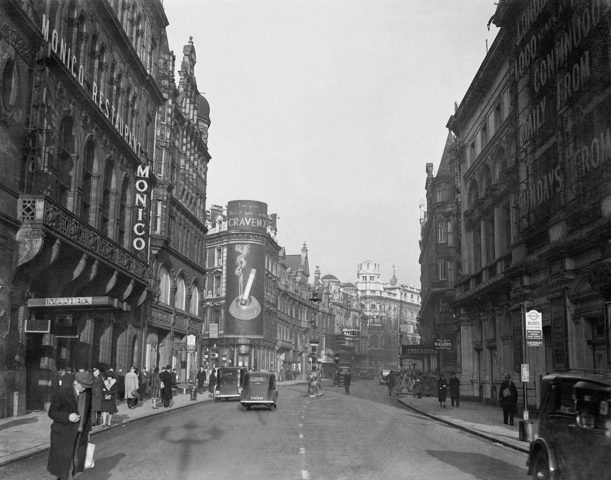 View down Shaftesbury Avenue towards Lyric and Apollo Theatres in 1940 with Monico Restaurant, Trocadero and Craven A cigarette advertisement