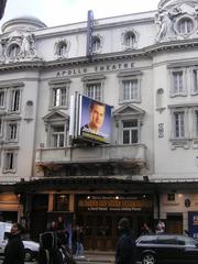 Apollo Theatre in London exterior view at dusk with illuminated marquee
