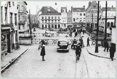 Historical street view of Smedenstraat with Toussein pipe shop, In de Toeslag café, Courtrai-Littoral hotel, barbershop, tram tracks and vintage automobile in Bruges
