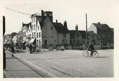 Historical railway crossing barrier from 1838 with 19th century stepped and list gables in a street scene including 'In den Toeslag' inn and 'Pijpen- en tabakhandel Toussein' with a round belvédère from 1839