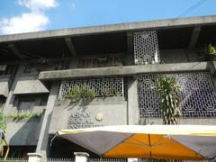 Busy intersection of Pedro Gil Street and Leon Guinto Street corner Agoncillo Street in Ermita and Paco districts, Manila with buildings and vehicles under clear sky