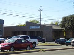 Front view of Little Walnut Creek Branch Library with surrounding greenery and clear sky