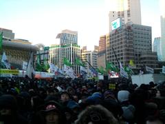 Large crowd of people gathered with flags and banners during the 2013 Korean Confederation of Trade Unions General Strike