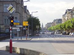 Luxembourg City train station building with distinctive tower at the end of the street