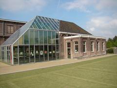 Historic brick electrical transformer house in Amsterdam with arched windows and decorative detailing