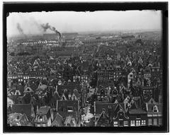 View of Egelantiersgracht canal in Amsterdam looking northwest towards Westerkerk with Westergasfabriek in background and smoke from Stoommeelfabriek De Weichel chimney on June 3, 1896