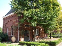 Historic meter house at Oost in Amsterdam with intricate brickwork and a steep gable roof