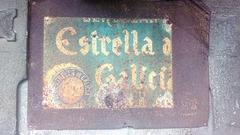 Vintage metal advertising sign of Estrella Galicia in A Graña, Ferrol