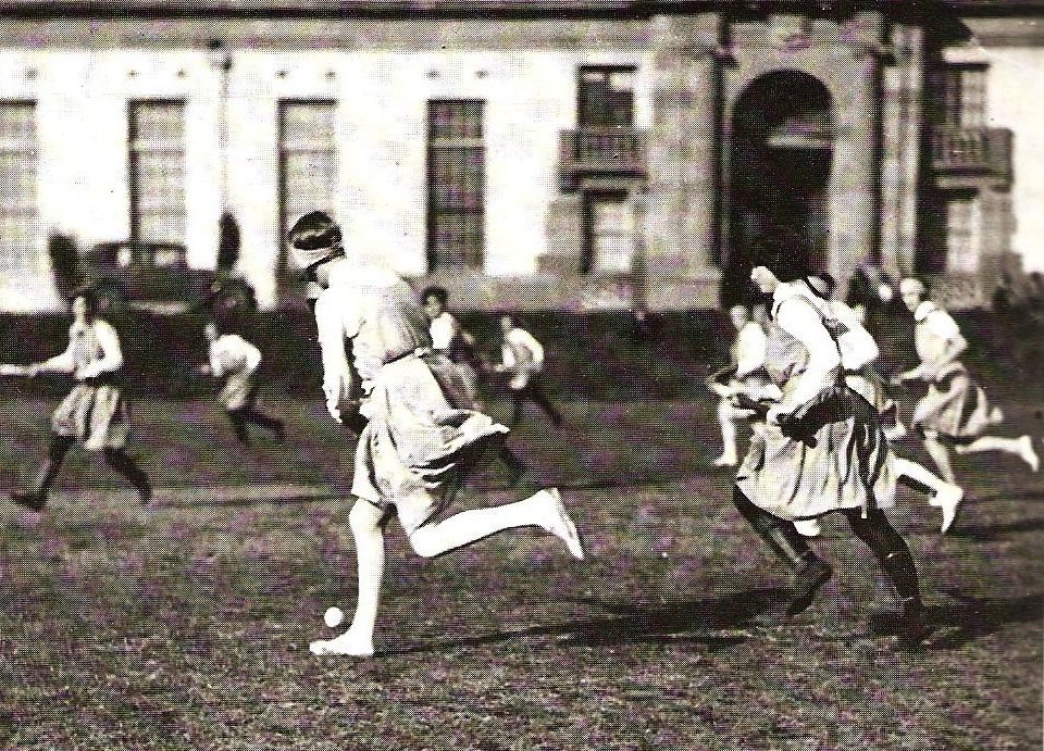 Women playing field hockey at the University of Sydney sports ground in 1910