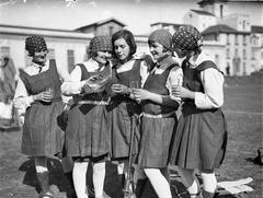 Five schoolgirl hockey players drinking lemonade at Sydney University circa 1925-1957