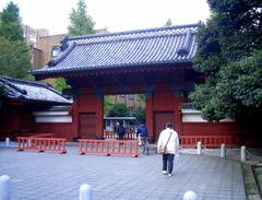 Akamon Gate at the University of Tokyo with traditional Japanese architecture, red pillars, and a tiled roof