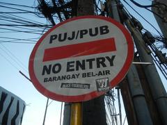 Urban street scene of Jupiter Street at the intersection with Makati Avenue and Kalayaan Avenue in Bel-Air Village, Makati City, featuring signage for Papa John's Pizza and Burger King