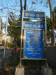 Intersection of Kalayaan Avenue and Nicanor Garcia Street in Bel-Air, Makati City with urban buildings and clear sky