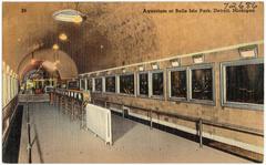 Aquarium building at Belle Isle Park in Detroit, Michigan with people walking nearby