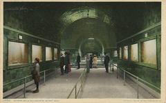 Interior view of Belle Isle Aquarium with fish tanks and visitors