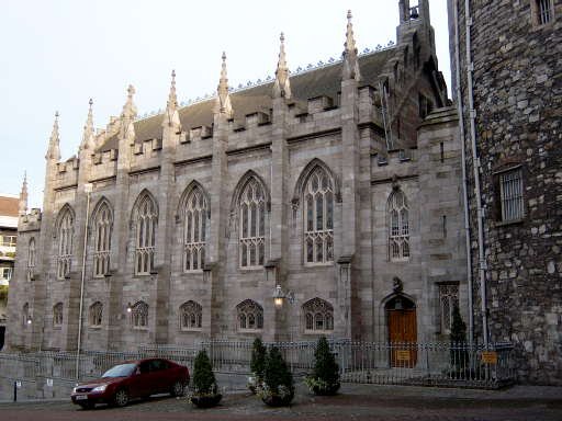 Interior of Dublin Castle's Chapel Royal with ornate Gothic Revival architecture and colorful stained glass windows