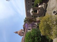 Exterior view of the former Benedictine Monastery in Catania, showcasing historical architecture with ornate windows and balconies