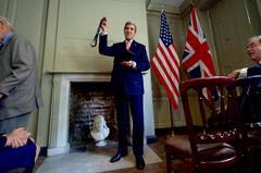 U.S. Secretary of State John Kerry raising the Benjamin Franklin Medal for Leadership at the Benjamin Franklin House in London