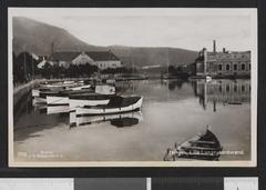 View of Lille Lungegårdsvann lake in Bergen, Norway with cityscape and mountains