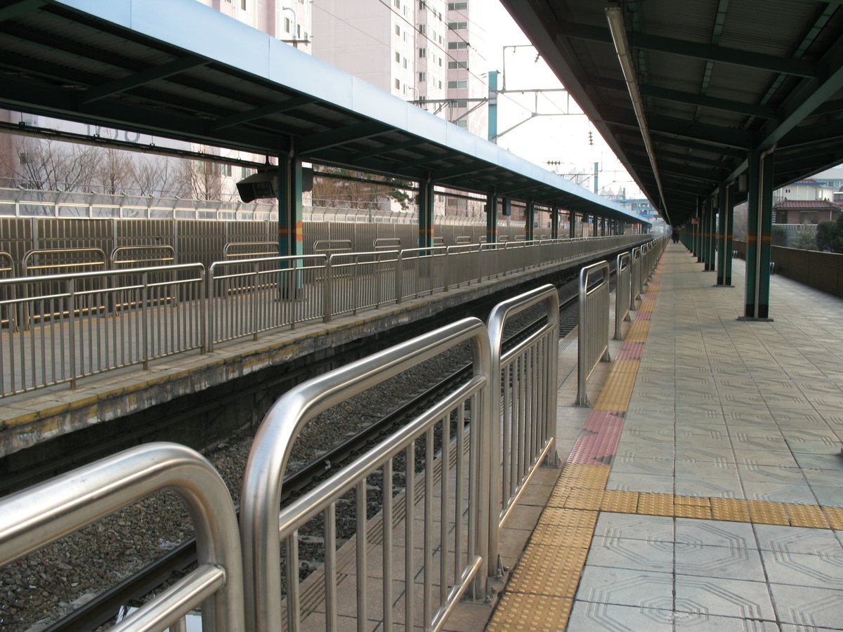 Hankuk University of Foreign Studies Station platform with tracks and overhead wires