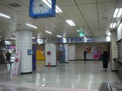 View of Suyu Station entrance with people walking