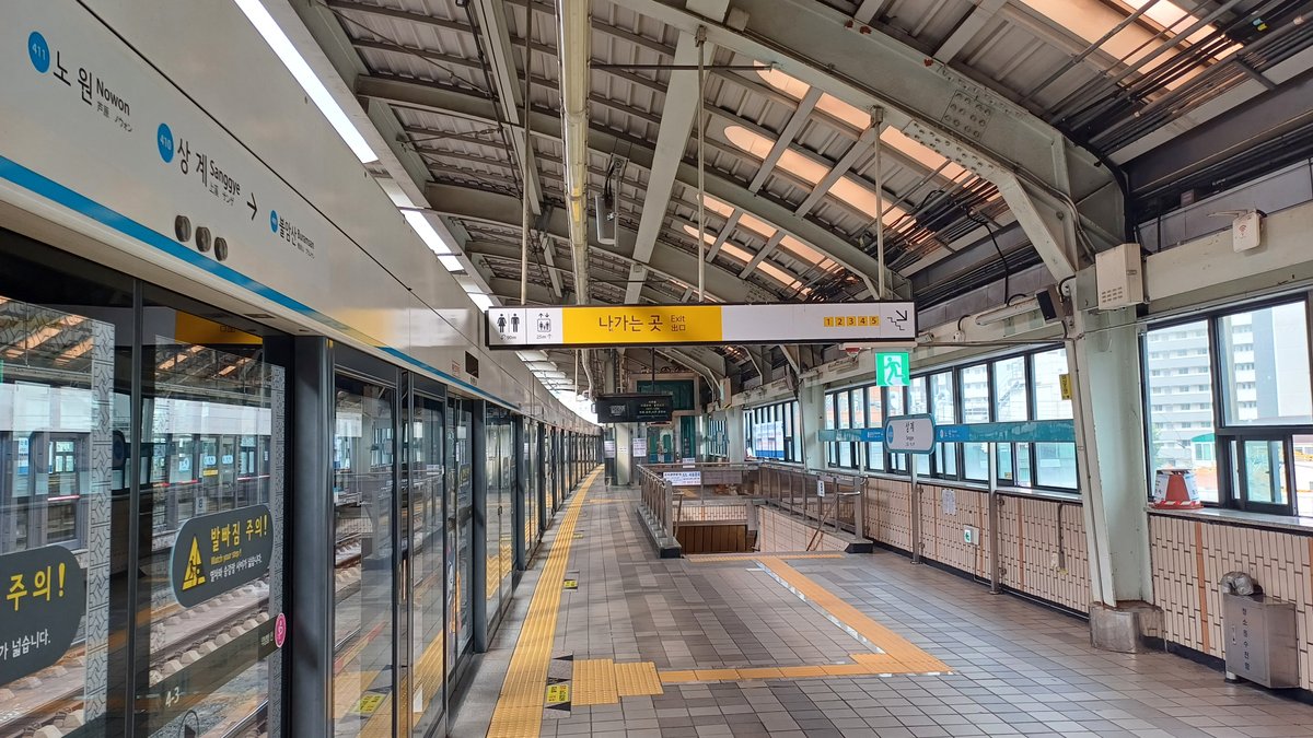 Sanggye Station platform with passengers and signage